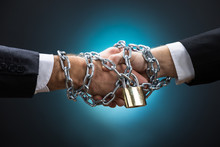 Chained Businessmen Shaking Hands