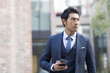 Confident businessman holding a smart phone