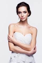 Wall Mural - Portrait of beautiful young brunette woman bride in white Weddin