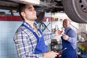 Two car mechanics at workshop