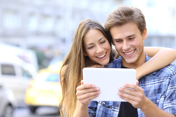 Sticker - Happy couple sharing a tablet in the street