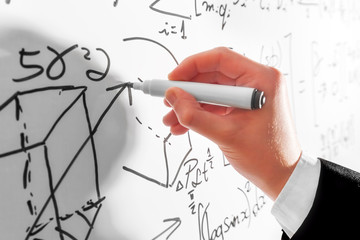 Wall Mural - Man writing complex math formulas on whiteboard. Mathematics and science
