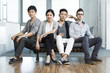 © Blue Jean Images - Young office workers sitting in sofa