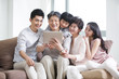 © Blue Jean Images - Happy family with digital tablet