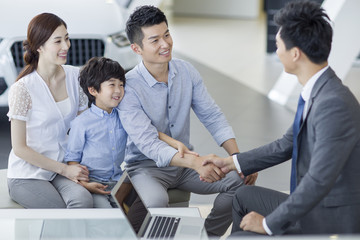 Wall Mural - Young family buying car in showroom