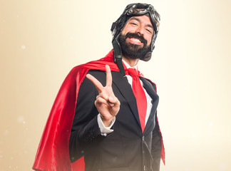 Super hero businessman doing victory gesture