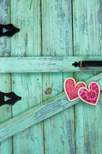Red Fabric Hearts Hanging On Antique Rustic Wood Door