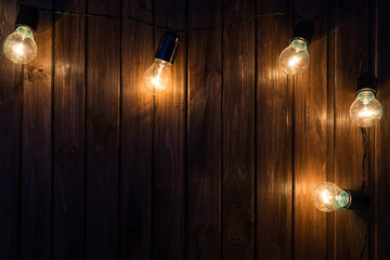 Light bulbs on dark Wooden Background