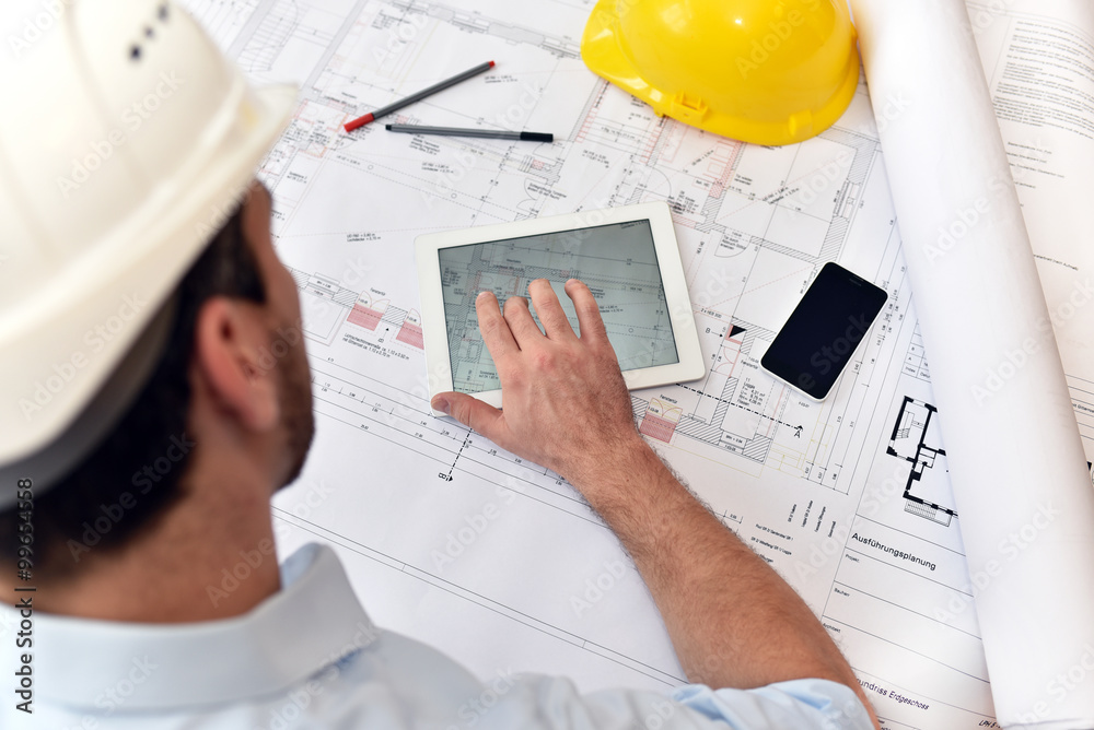 Planung und Entwicklung im Bauwesen - Architekt mit Tablet und techn. Zeichnung am Arbeitsplatz - obrazy, fototapety, plakaty 