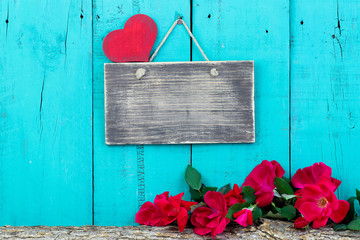 Wall Mural - Blank sign and red roses by wood background