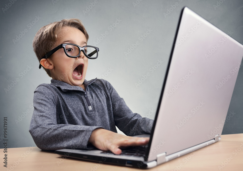 Shocked and surprised boy on the internet with laptop computer - obrazy, fototapety, plakaty 
