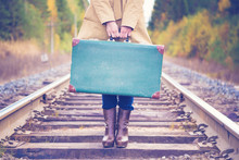 Elegant Woman With A Suitcase Traveling By Rail.