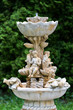 Marble garden water fountain with statues of little boys and fish. The palace and park complex Manor Tarnowski, s.Kachanovka, Ukraine.