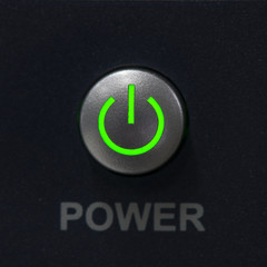 Power switch push button and green light power on symbol.
