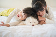 siberian husky lying with asian children on white bed
