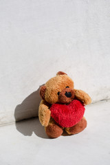 Wall Mural - Teddy bear with a heart on a white background