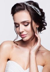 Wall Mural - Portrait of beautiful young brunette woman bride in white Weddin