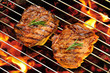 Grilled pork steaks on the flaming grill