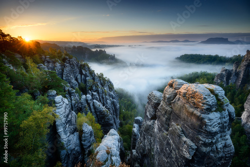 Fotografie, Obraz Foggy sunrise at Bastei, Saxon Switzerland, Germany