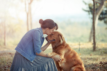 Beautiful Woman With A Cute Golden Retriever Dog