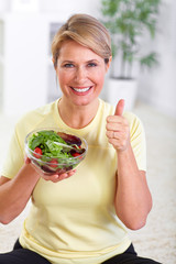 Sticker - Elderly woman eating salad.