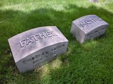 Mother And Father Tombstones Adjacent In The Grass