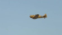 Bright Yellow T-6 Harvard Trainer (also Known As A Texan) In Flight.  Used By Canada And The United States For Pilot Training.  Recorded In 4K, Ultra High Definition.