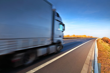 Wall Mural - White truck driving through the autumn landscape