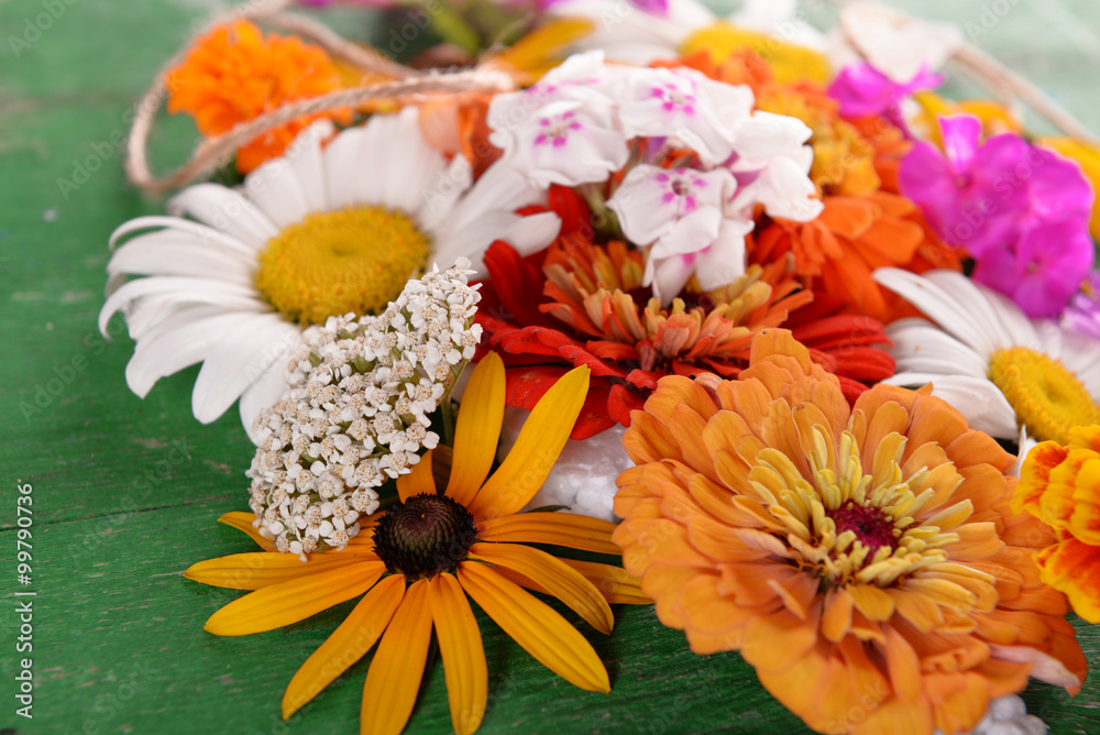 Fresh colorful flowers on wooden table, closeup