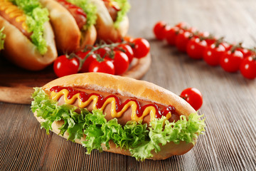 Sticker - Tasty hot-dog with tomatoes on wooden table