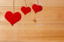 Handmade Hearts Hanging On Line Against Wood-grain Wall