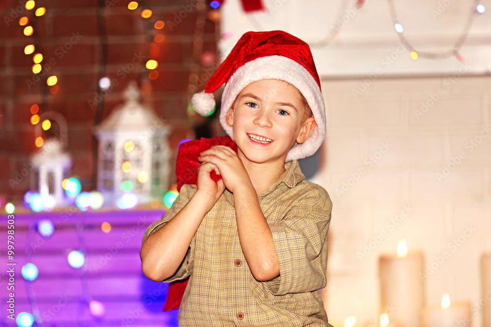 Little boy with Santa bag on a Christmas background