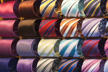 different colors silk tie on display stand
