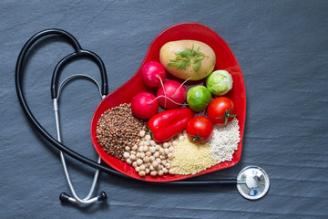 Wall Mural - Healthy food on red heart plate cholesterol diet concept
