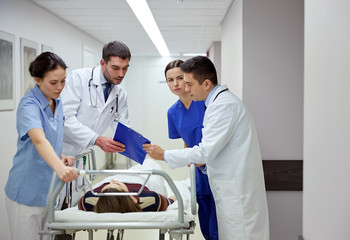 Canvas Print - medics and patient on hospital gurney at emergency