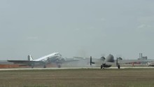 Douglas C-47 Skytrain Historic Military Transport And B-25 Mitchell Bomber Wait On Taxiway At Airfield.  Recorded In 4K, Ultra High Definition.