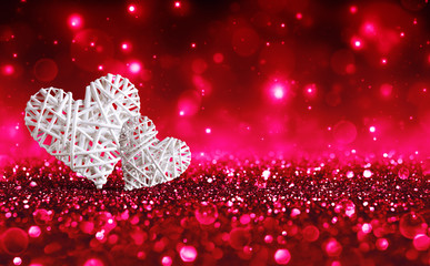 Wall Mural - two wicker hearts on red sparkle glitter