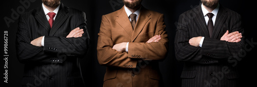 Fotografie, Obraz Group of three men in suits black background