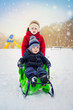 © golovianko - Cute kids on sledge in winter park