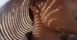 © rocketclips - Extreme close up of Black woman with sunhat and diamond earing