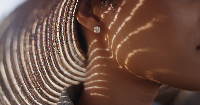 Wall Mural -  - Extreme close up of Black woman with sunhat and diamond earing