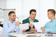 © Africa Studio - Young business men at the meeting in a conference room