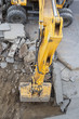 Wheeled excavator digs dirt, asphalt and gravel.