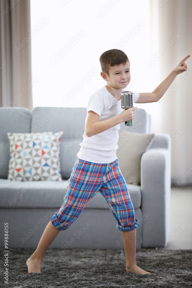 Little boy with microphone at home