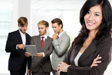 Poster - Young asian businesswoman, with her team behind isolated in whit