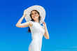 © frolova_elena - Beautiful brunette bride in white wedding dress and straw hat ha