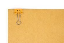 Orange Happy Face Paperclip Nipped At Brown Paper On White Background. 