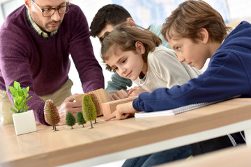 Wall Mural - School teacher in science class with pupils