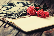 Photoalbum With Rose On Wooden Table