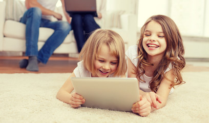 smiling sister with tablet pc and parents on back